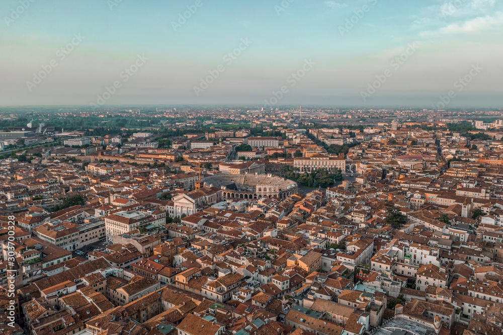Aerial drone shot view of sunrise on historic Verona city center with red brick city skyline