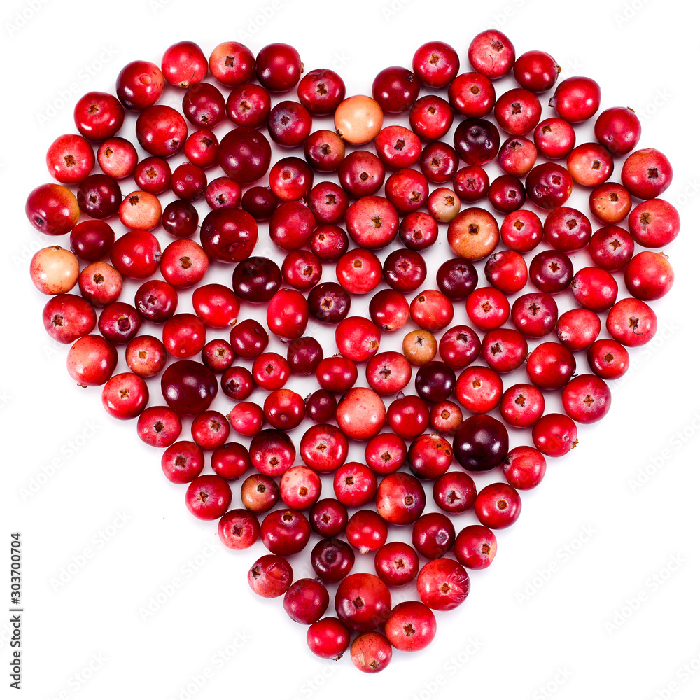 Heart made of ripe cranberries isolated on a white background. Top view. Heart made of ripe cranberries isolated on a white background. Top view.