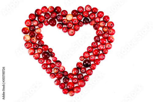 Heart made of ripe cranberries isolated on a white background. Top view.