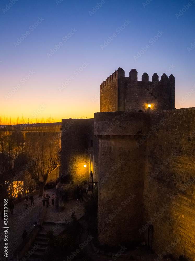 Sunset view of the old town walls, decorated for Christmas, in Obidos, Portugal