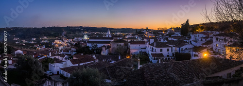 Sunset view of the old town walls, decorated for Christmas, in Obidos, Portugal