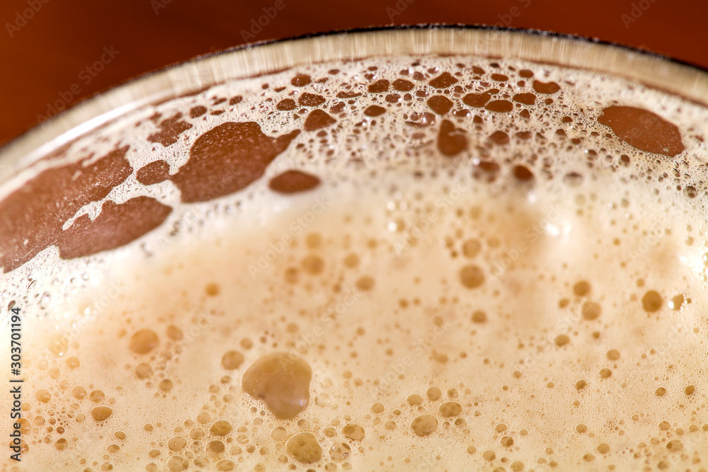 Selective focus. Glass of beer. Top view. Foam and bubbles close up. Selective focus. Glass of beer. Top view. Foam and bubbles close up.