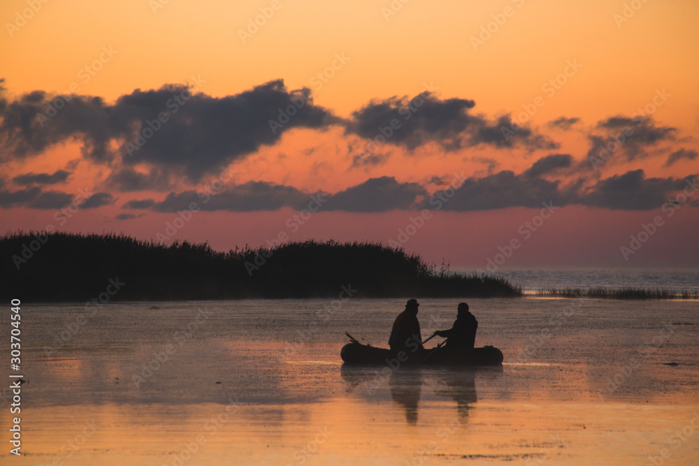fishermen in a boat at dawn, bright colors