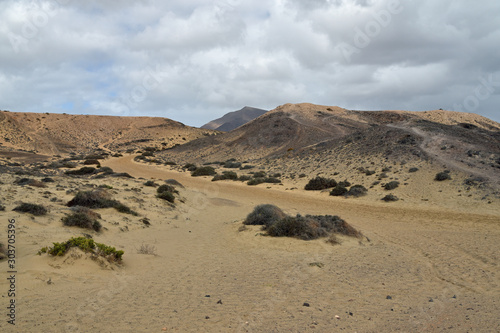 Pathway from Caleta del Congrio beach near Papagayos in Lanzarote with stunning volcanic/desert landscape