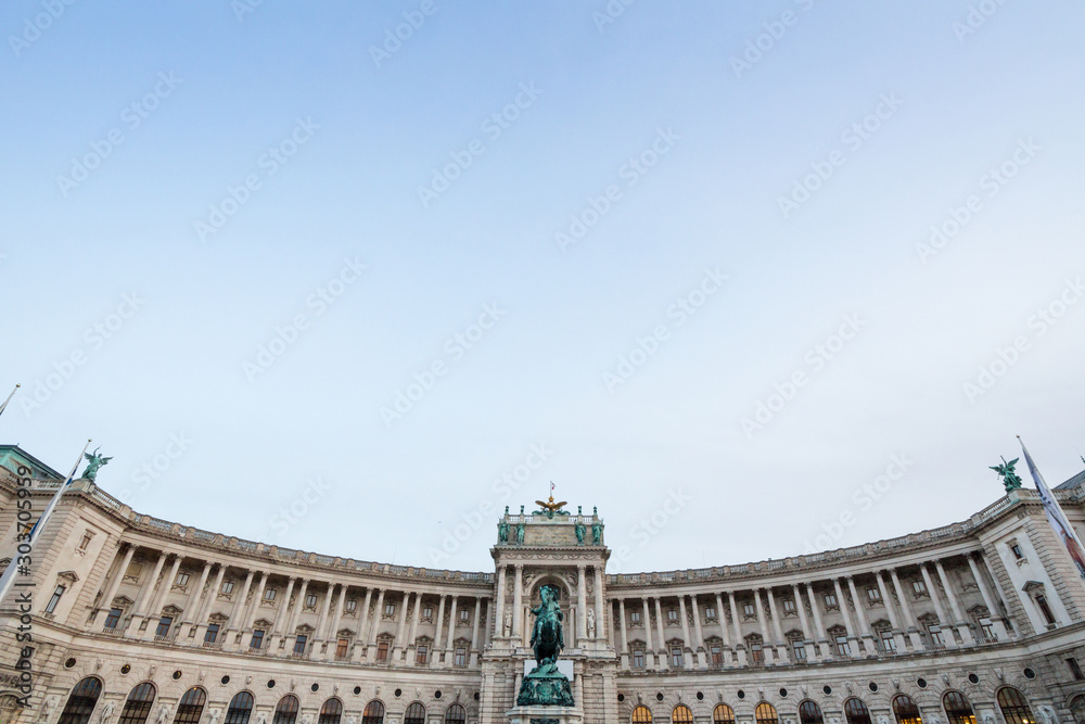 Obraz premium Hoffburg palace, on its Neue Burg aisle, taken from the Heldenplatz square, with the 19th century Prinz Eugen statue in front in Vienna, Austria. It is the former Austro Hungarian imperial palace