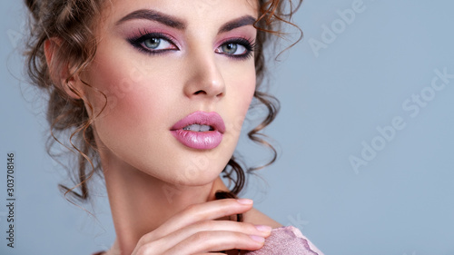 Young woman with bright eye make-up, long eye lashes. Young girl with attractive face. Portrait of a beautiful woman with vivid makeup. Young  model with beautiful face - isolated on white background