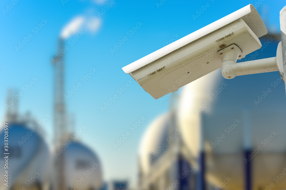 CCTV camera concept with refinery on background CCTV camera concept with refinery on background