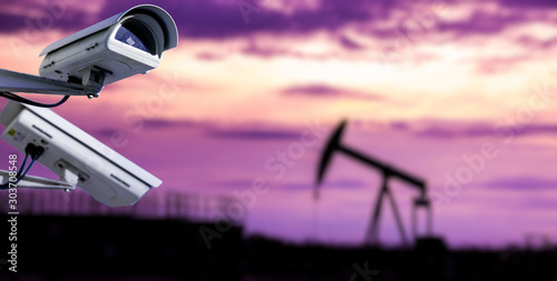 Photos CCTV camera concept with silhouettes of oil well