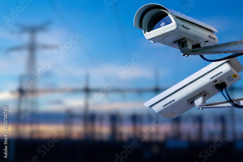 CCTV camera concept with power station on background