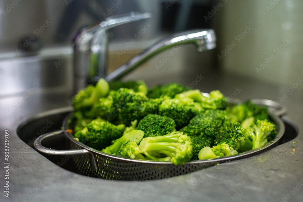fresh broccoli washed in the sink, fresh broccoli washed in the sink,