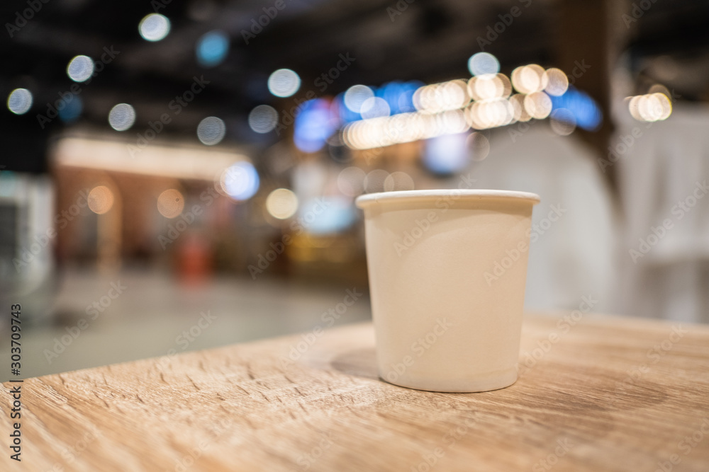 A cup of tea paper placed on a wooden table with free space A cup of tea paper placed on a wooden table with free space