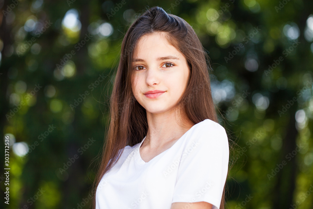 Close up brunette girl in summer park background Close up brunette girl in summer park background
