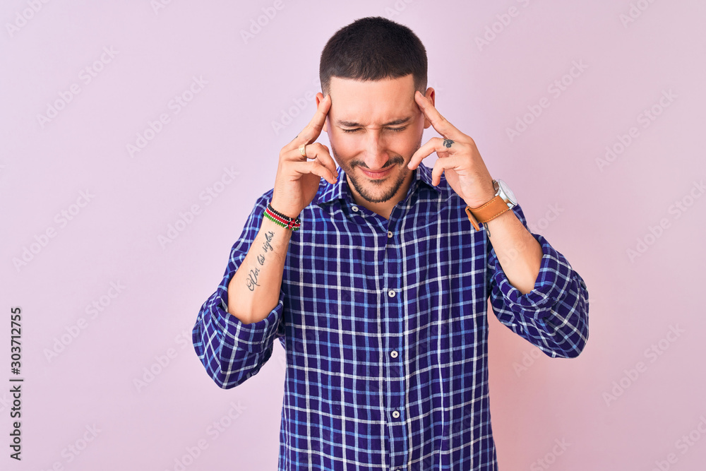 Young handsome man standing over isolated background with hand on head for pain in head because stress. Suffering migraine. Young handsome man standing over isolated background with hand on head for pain in head because stress. Suffering migraine.
