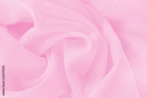 Soft pink fabric cloth texture for background and design art work, beautiful crumpled pattern of silk or linen.