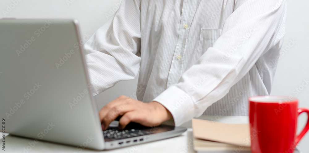 Businessman working at home office with laptop and documents on his desk, start-up business concept.