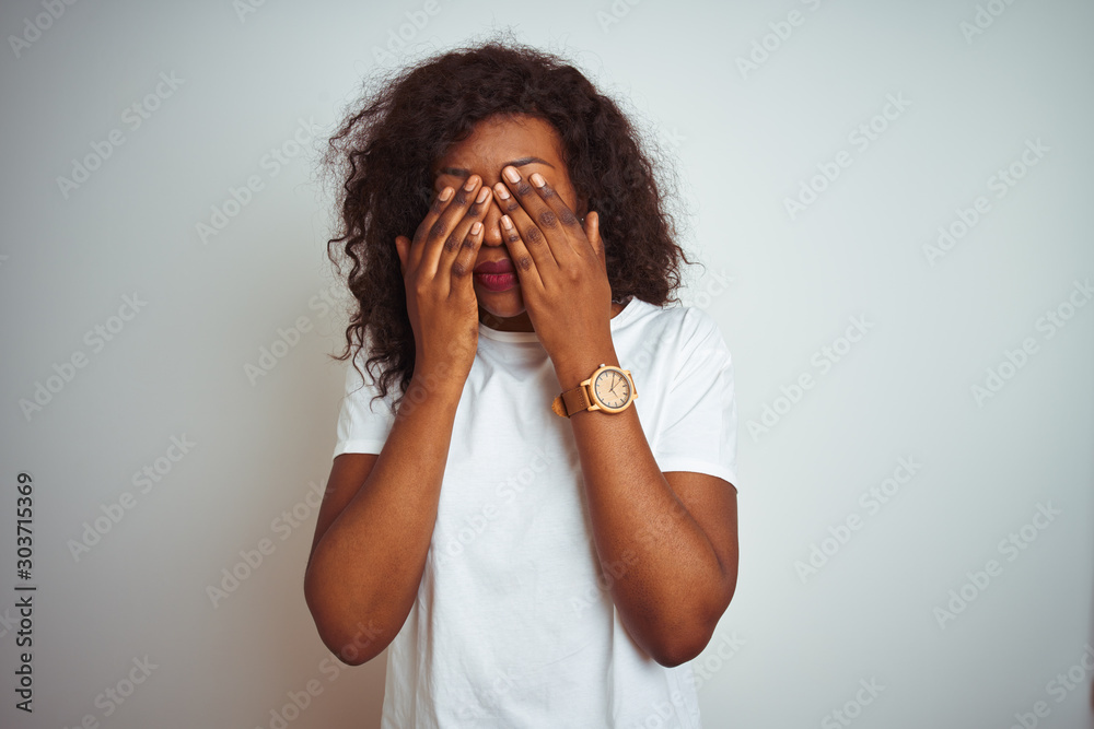 Young african american woman wearing t-shirt standing over isolated white background rubbing eyes for fatigue and headache, sleepy and tired expression. Vision problem Young african american woman wearing t-shirt standing over isolated white background rubbing eyes for fatigue and headache, sleepy and tired expression. Vision problem