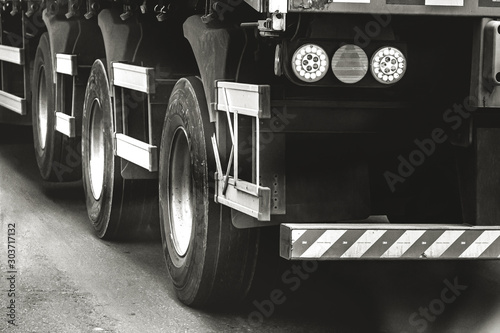 Black and white photo of a rear of a truck. photo