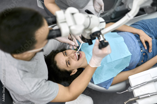 Pretty woman s teeth treatment in dental clinic