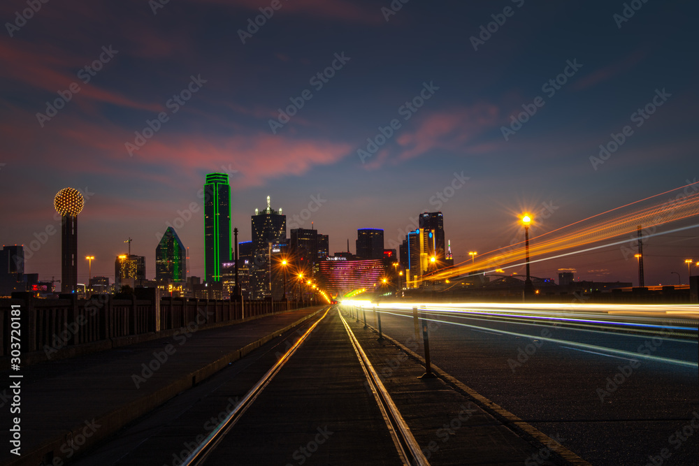 Dallas Texas. Long exposure with streaking car and train lights and clouds
