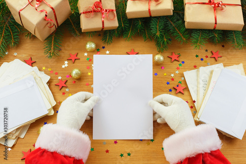 Close-up of Christmas letter in Santa Claus hands © ukrolenochka