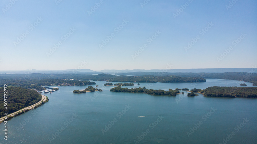 Aerial view of blue lakes and green forests on a sunny summer day in Finland. drone photography