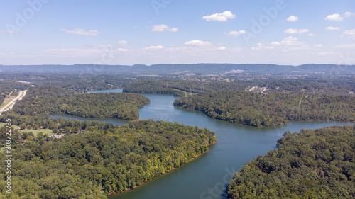 Fototapeta Naklejka Na Ścianę i Meble -  Aerial view of road between green summer forest and river