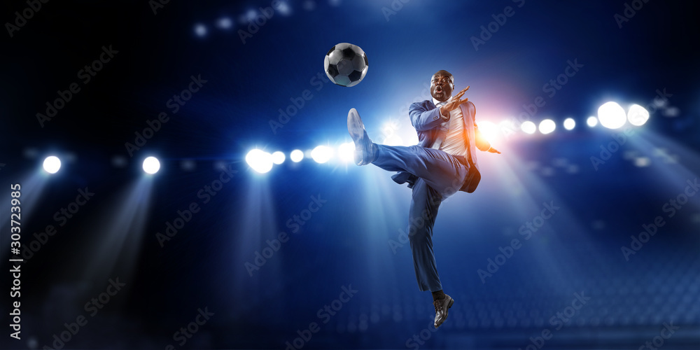Soccer businessman in action with ball. Mixed media