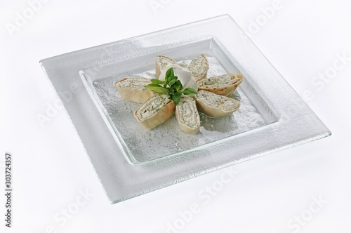 Cuadro en lienzo Isolated shot of a white plate with cottage cheese rolls - perfect for a food bl