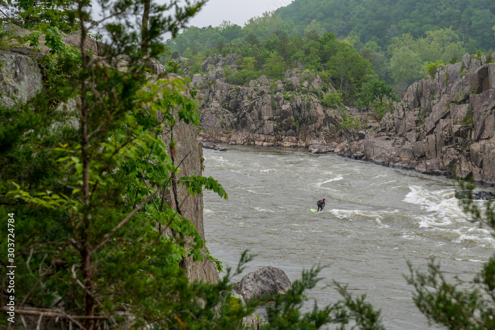 Man on Kayak in wetsuit on kayak on the river Man on Kayak in wetsuit on kayak on the river