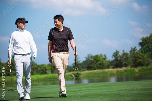 Two Male professional golfer asian funny after completing the golf course. Friendship and success. sport Golfer concept.