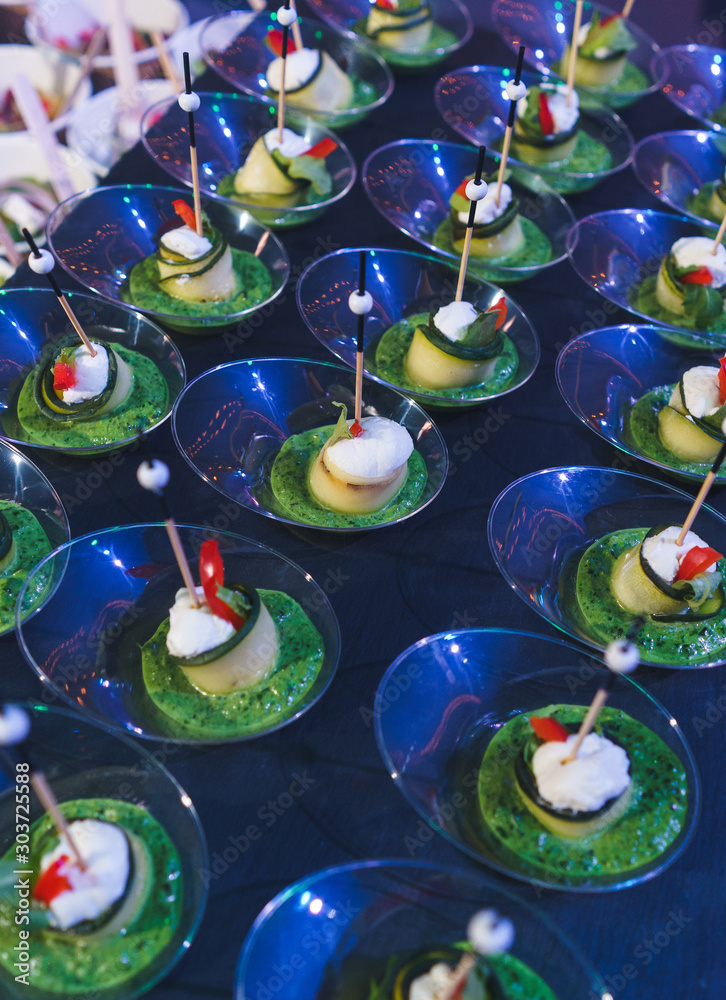 Canapes with cheese and vegetables. Catering and guest meals during the event.
