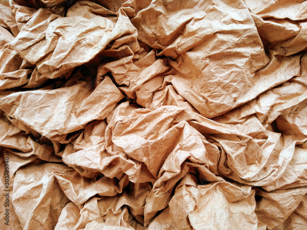 Crumpled paper ball isolated on white background. Crumpled paper texture. Brown crumpled paper texture for background. Crumpled paper ball isolated on white background. Crumpled paper texture. Brown crumpled paper texture for background.