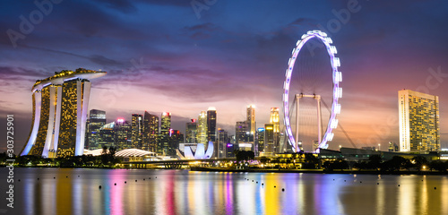 Stunning view of the Marina Bay skyline with beautiful illuminated skyscrapers during a breathtaking sunset in Singapore. Singapore is an island city-state off southern Malaysia.