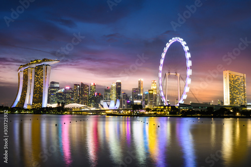 Stunning view of the Marina Bay skyline with beautiful illuminated skyscrapers during a breathtaking sunset in Singapore. Singapore is an island city-state off southern Malaysia.