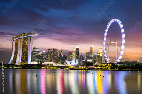 Stunning view of the Marina Bay skyline with beautiful illuminated skyscrapers during a breathtaking sunset in Singapore. Singapore is an island city-state off southern Malaysia.