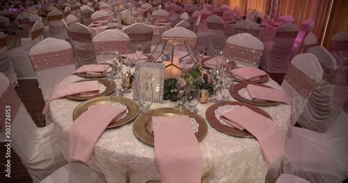 Eye catching inexpensive decoration ideas for a wedding party table with event lighting in the background photo