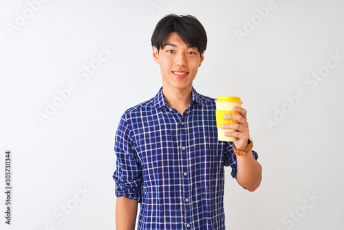Young chinese man drinking take away coffee standing over isolated white background with a happy face standing and smiling with a confident smile showing teeth