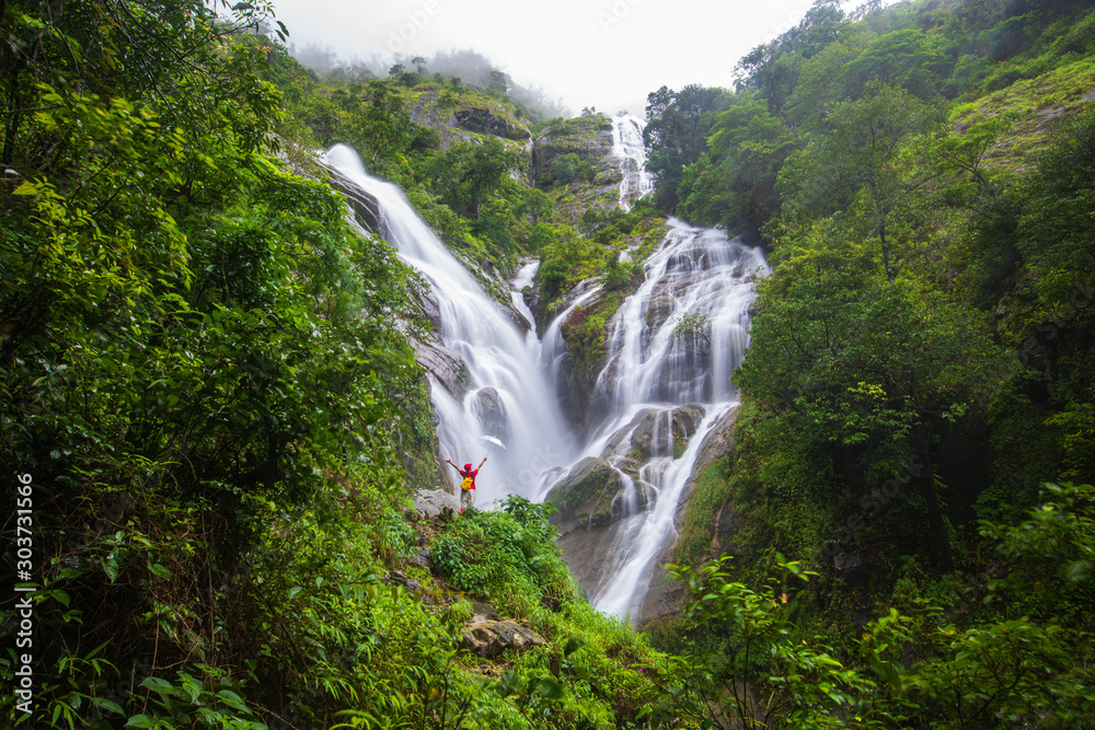 Young girl hiking on Pi-tu-gro waterfall, Beautiful waterfall in Tak province, ThaiLand. Young girl hiking on Pi-tu-gro waterfall, Beautiful waterfall in Tak province, ThaiLand.