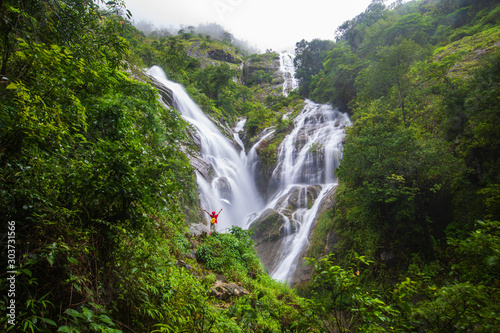 Young girl hiking on Pi-tu-gro waterfall, Beautiful waterfall in Tak province, ThaiLand.