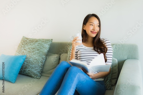 Portrait beautiful young asian women reading book with coffee cup