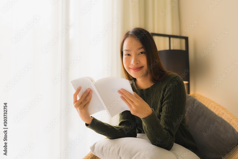 Portrait beautiful young asian women reading book and sitting on sofa chair Portrait beautiful young asian women reading book and sitting on sofa chair