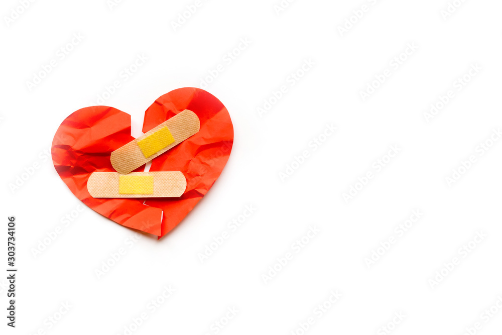 Broken red heart symbol with medical patch on white background, love concept. healing
