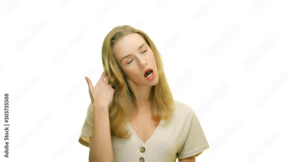 The young woman is fed up with everything, she is bored and tired. Studio portrait on white background. The young woman is fed up with everything, she is bored and tired. Studio portrait on white background.