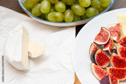 Green grapes, fresh figs and white cheese on the table