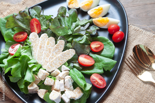 Fresh salad with tempeh or tempe, original plant based food of Indonesia