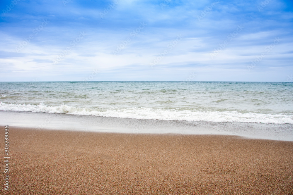 A beautiful sea and sand with nice blue sky and cloud.