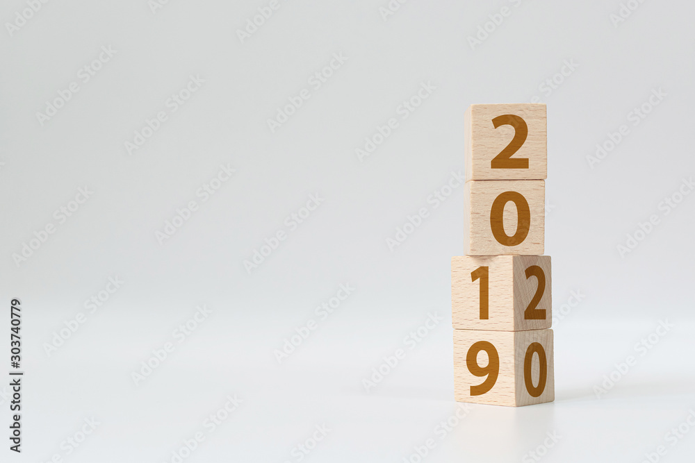New year 2019 change to 2020 concept. Wooden cube block flip over change years New year 2019 change to 2020 concept. Wooden cube block flip over change years