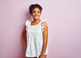 Young beautiful african american teenager girl standing wearing elegant white t-shirt