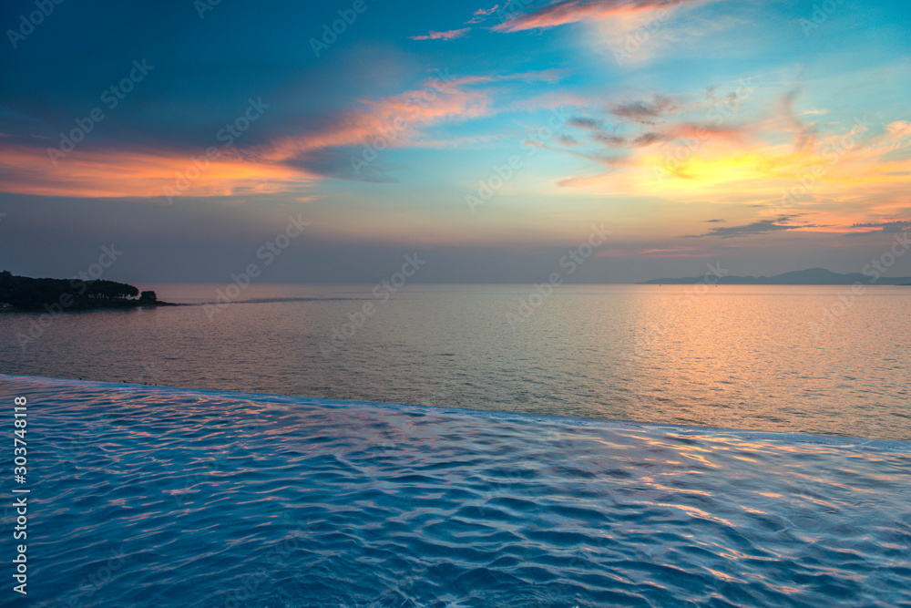 Swimming Pool with sunset on the sea