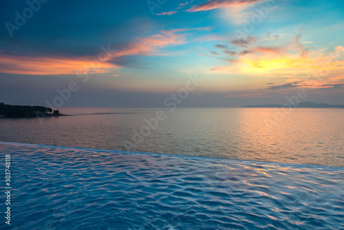 Swimming Pool with sunset on the sea © opasstudio